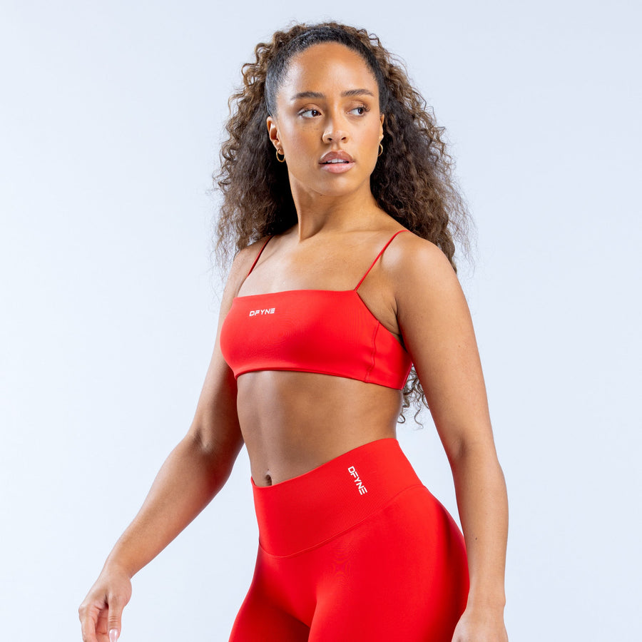 Red strappy sports bra with smooth cups and thin shoulder straps