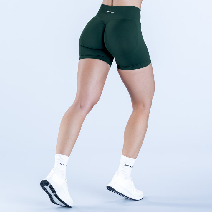 Dark green athletic shorts with contoured back panel and short inseam