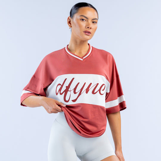 Short-sleeve birthday top with burgundy sleeves, white center stripe, cursive logo