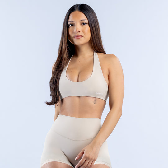 Cream backless halter bra with scoop neckline and wide underband