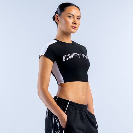 Black baby T-shirt with DFYNE graphic logo, contrasting white sleeve panels.