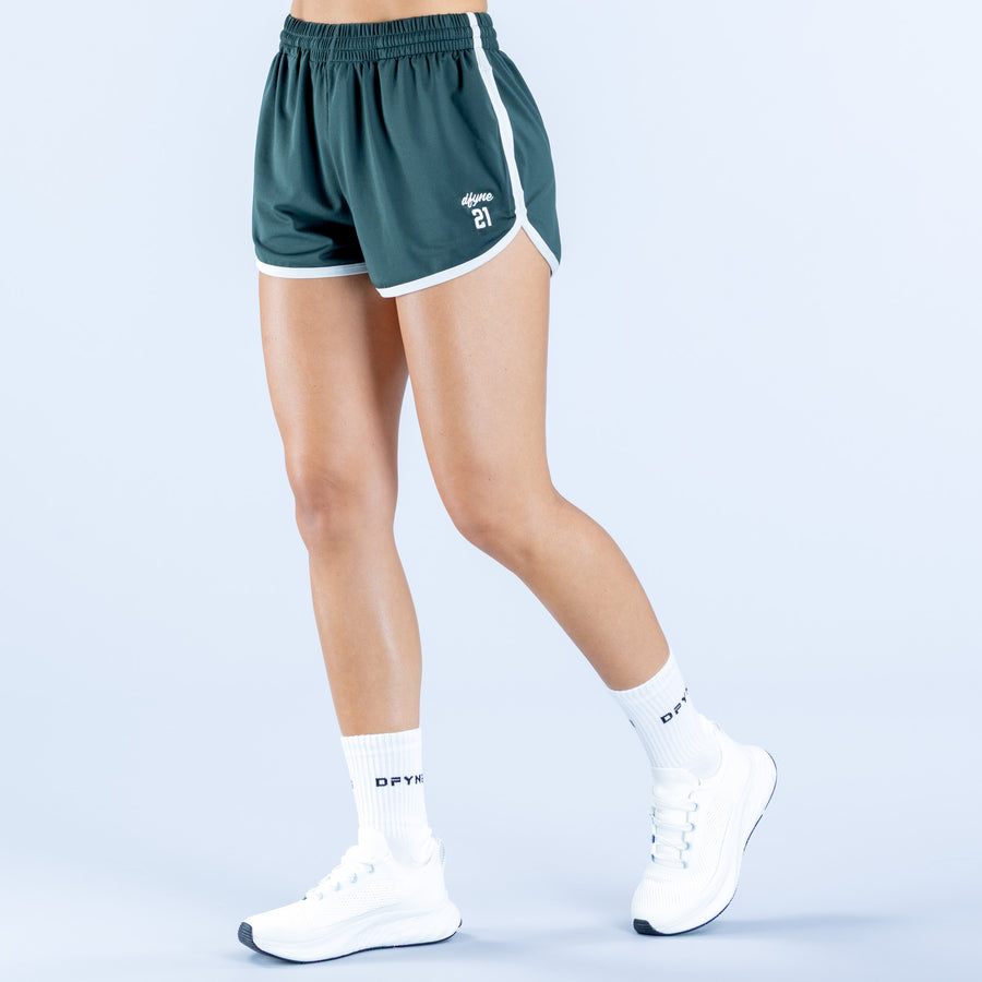 4th birthday shorts in dark green, white hem trim; side view