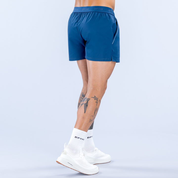 Men's blue training shorts with elastic waistband and small side logo