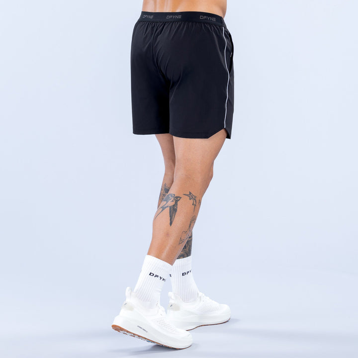 6-inch black training shorts, back view, elastic waistband and logo at hem