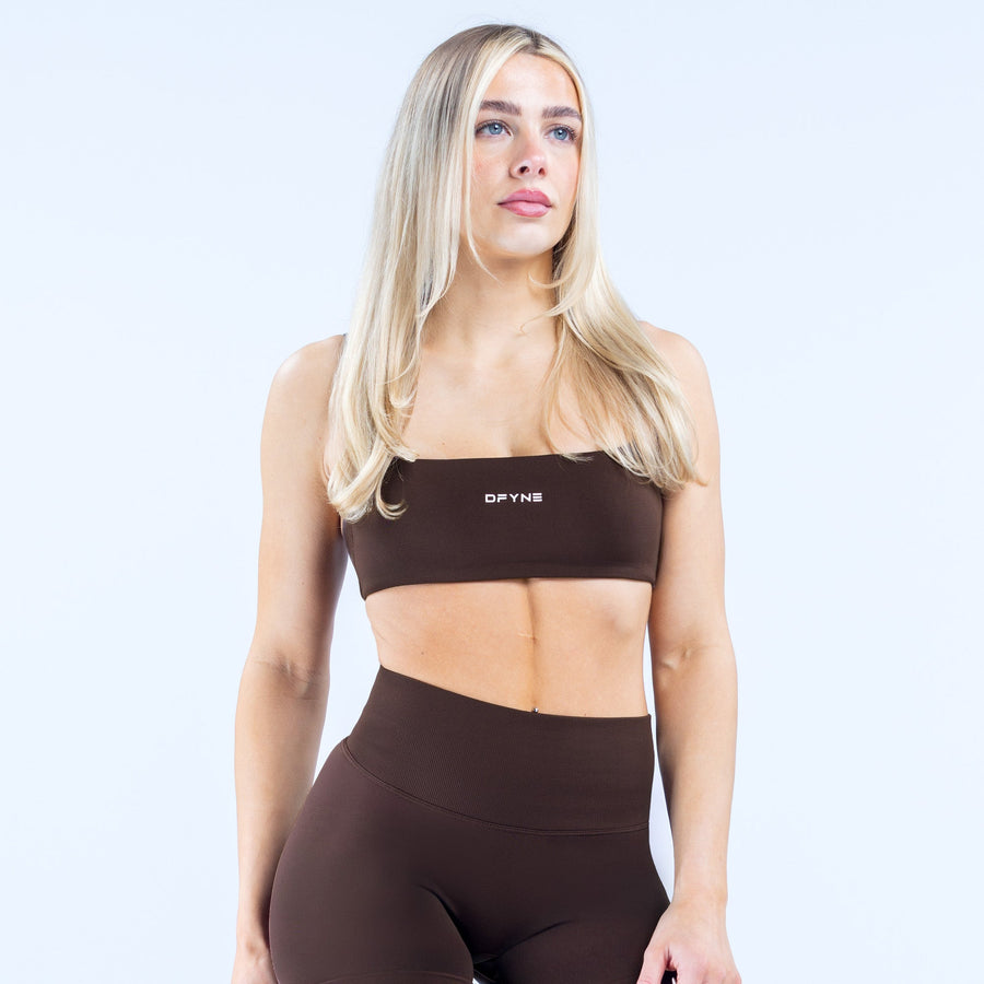 Women’s strappy sports bra front view, dark fabric and wide underband