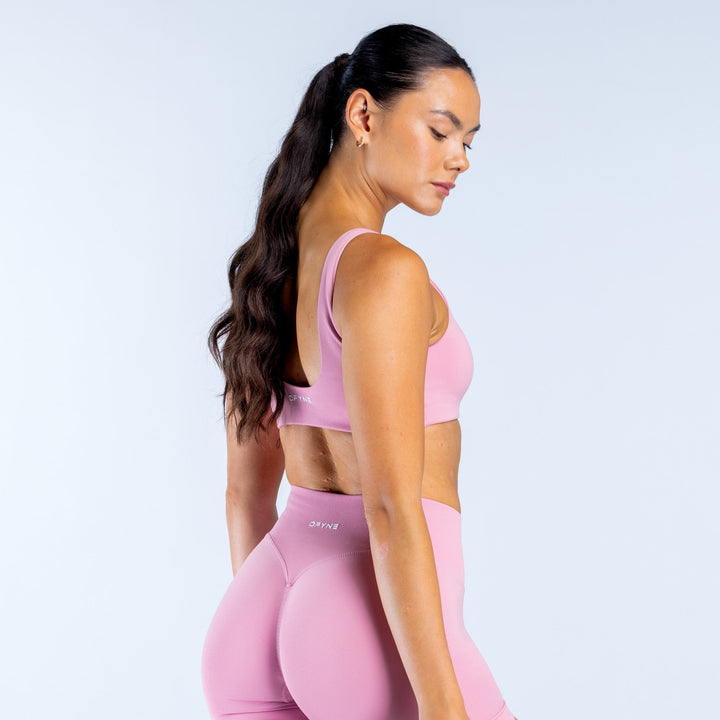 Pink scoop-back sports bra, side view showing racerback straps