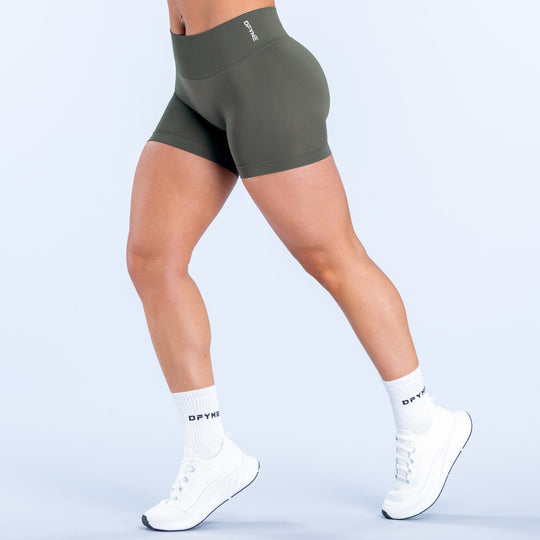 Olive green 4.5-inch compression-style shorts with smooth, fitted stretch.