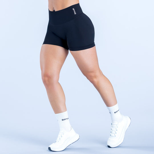 Black 4.5-inch athletic compression shorts, side view, smooth stretch fabric