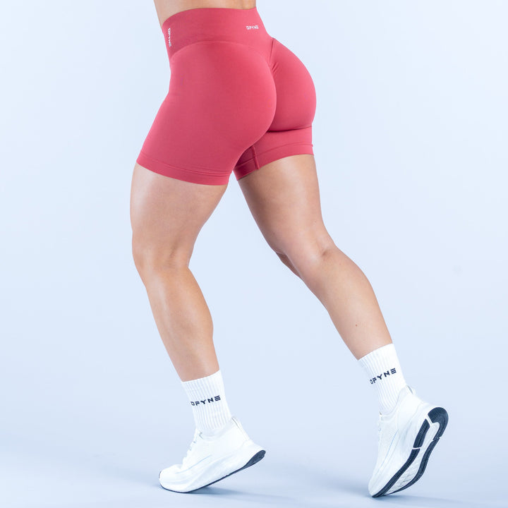 Women's 4.5-inch pink compression shorts, rear view with contoured seams