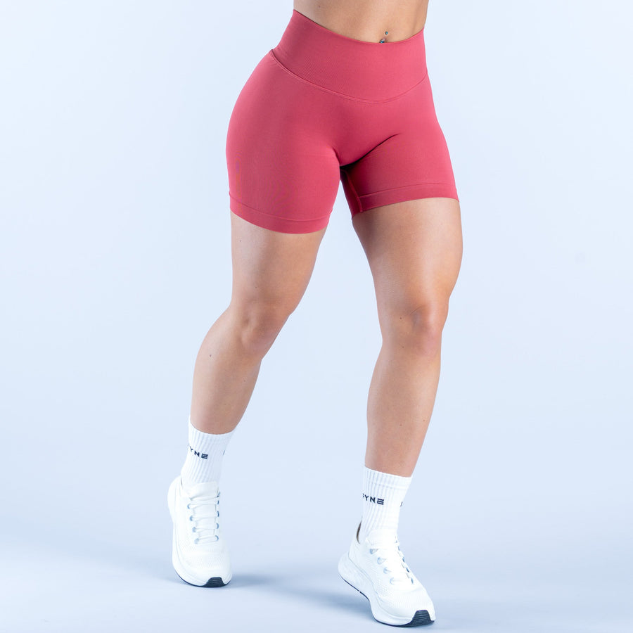Women's 4.5-inch pink compression shorts with smooth fabric and wide waistband