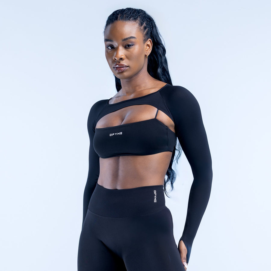 Black long-sleeve shrug crop top with wide neckline cutout at chest
