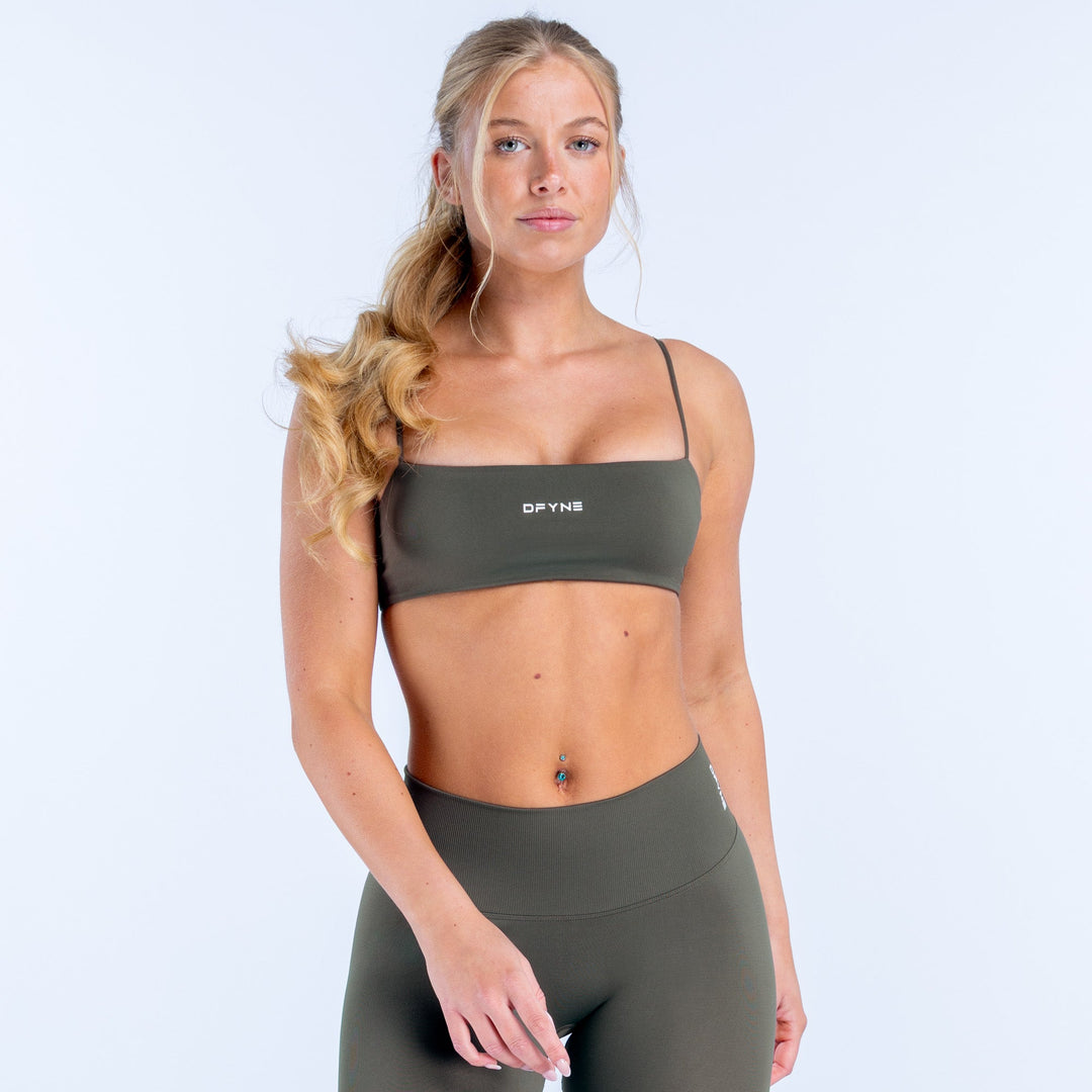 Dark green strappy sports bra with scoop neckline and DPYN logo band