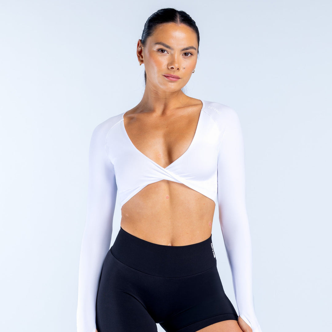 White long-sleeve sports top with V-neck twist front and fitted wrap bodice