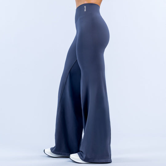 Navy wide-leg flare leggings with high waist and visible side panel detail