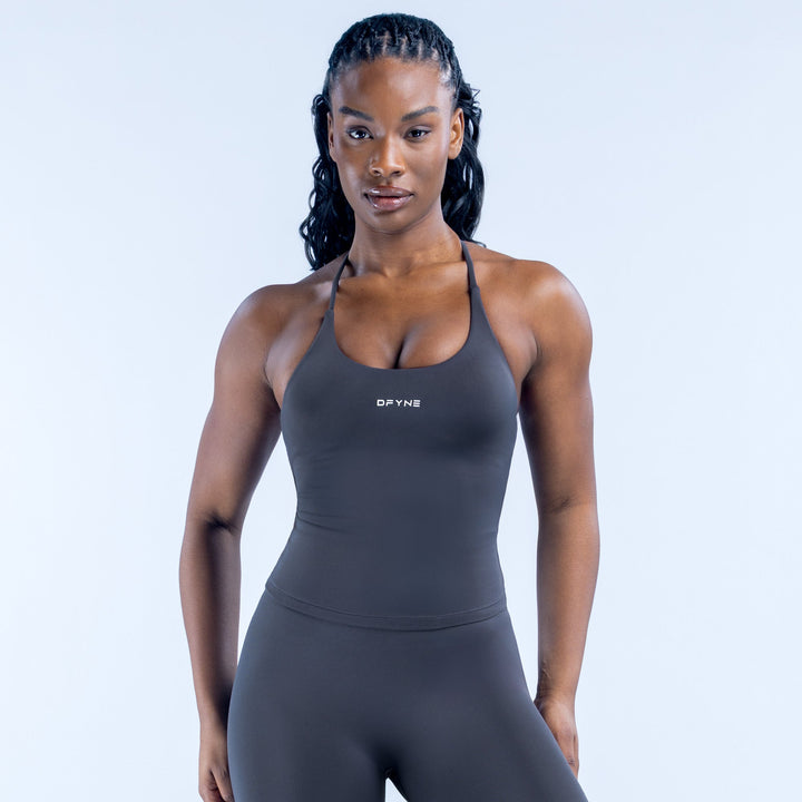 Twist-back athletic top with halter neckline, black fabric, front logo