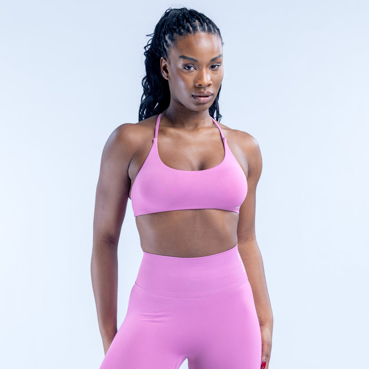 Pink sports bra with scoop front and thin adjustable straps