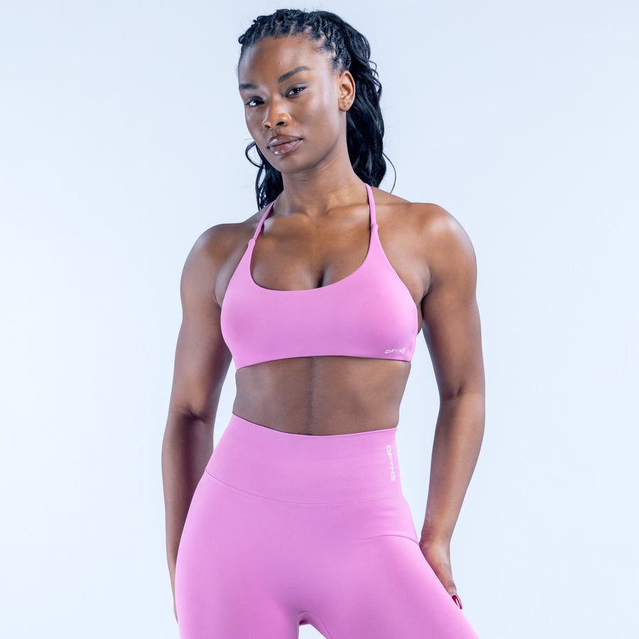 Pink sports bra with scoop neckline and slim adjustable straps