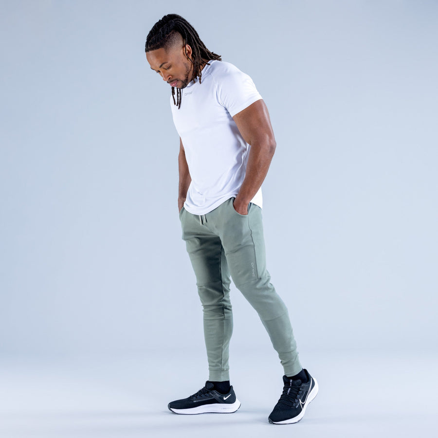 Sage green tapered jogger pants with drawstring waistband and ankle cuffs