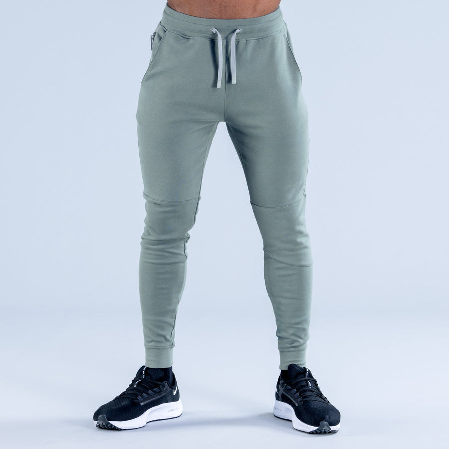 Sage green tapered jogger pants with drawstring waistband and tapered leg fit