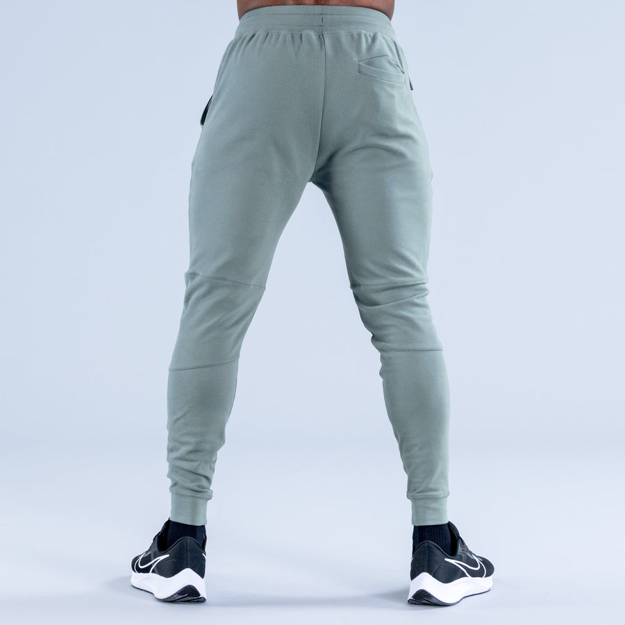 Sage green tapered jogger pants with elastic back waistband and ankle cuffs