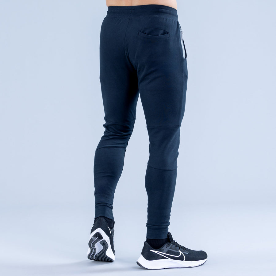Dark navy tapered jogger pants with elastic waistband and side pockets