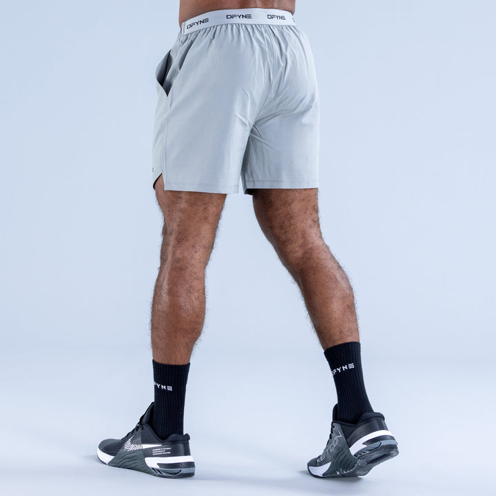 Men's light blue training shorts, back view, elastic waistband and DPYNE logo
