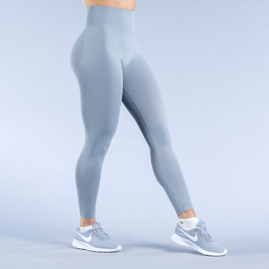Sky-blue leggings, back view with tapered ankle cuffs and logo accents