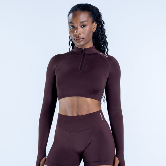 Maroon impact crop jacket with quarter zip and long sleeves, fitted athletic top