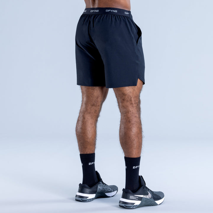 Dark navy training shorts, back view with elastic waistband logo band