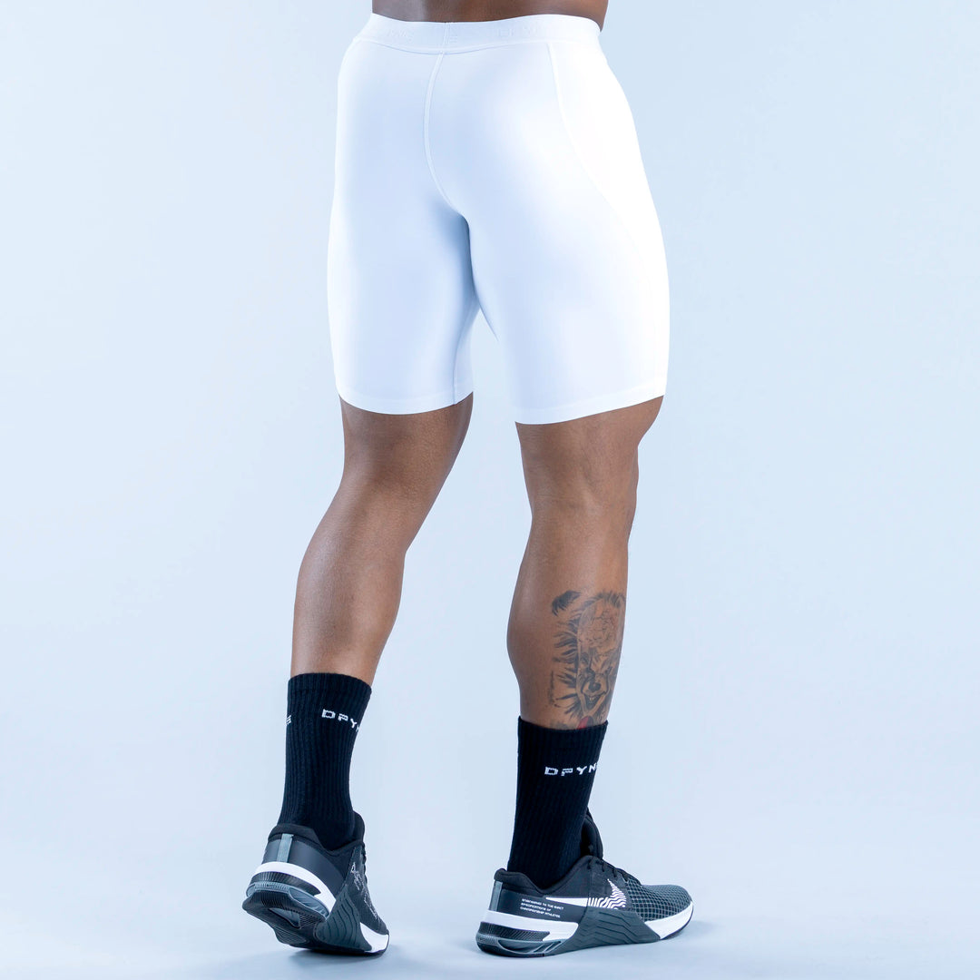 White compression base-layer shorts, knee-length with contoured legs and seam details