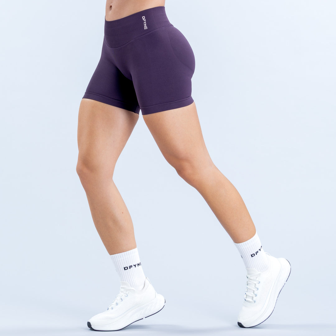 Purple 4.5-inch fitted shorts with a wide high-rise waistband, front view.