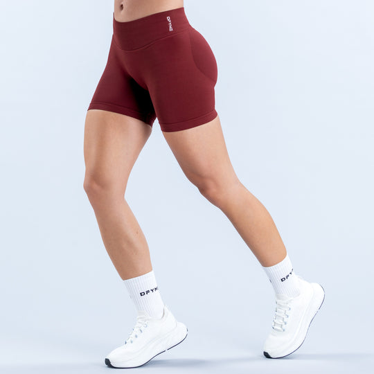 Burgundy 4.5-inch athletic shorts with a high waistband, shown from the side.