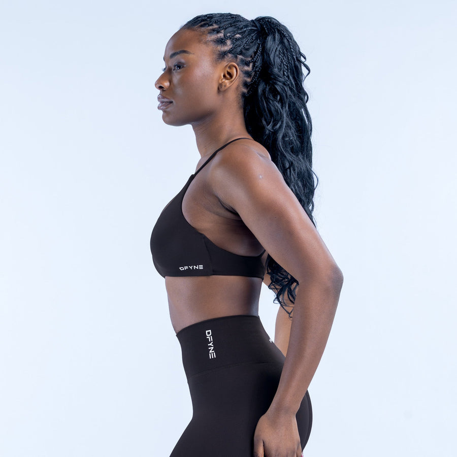 Black sports bra with low scoop front and open, crisscross back