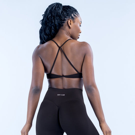 Black sports bra with crisscross back straps and wide elastic band