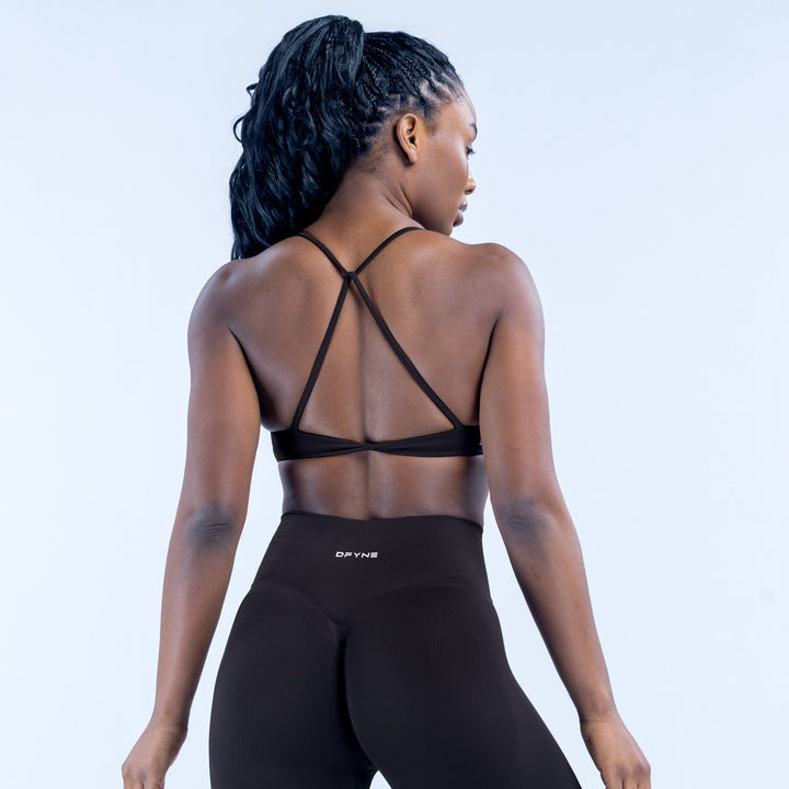 Black sports bra with crisscross back straps and wide elastic band