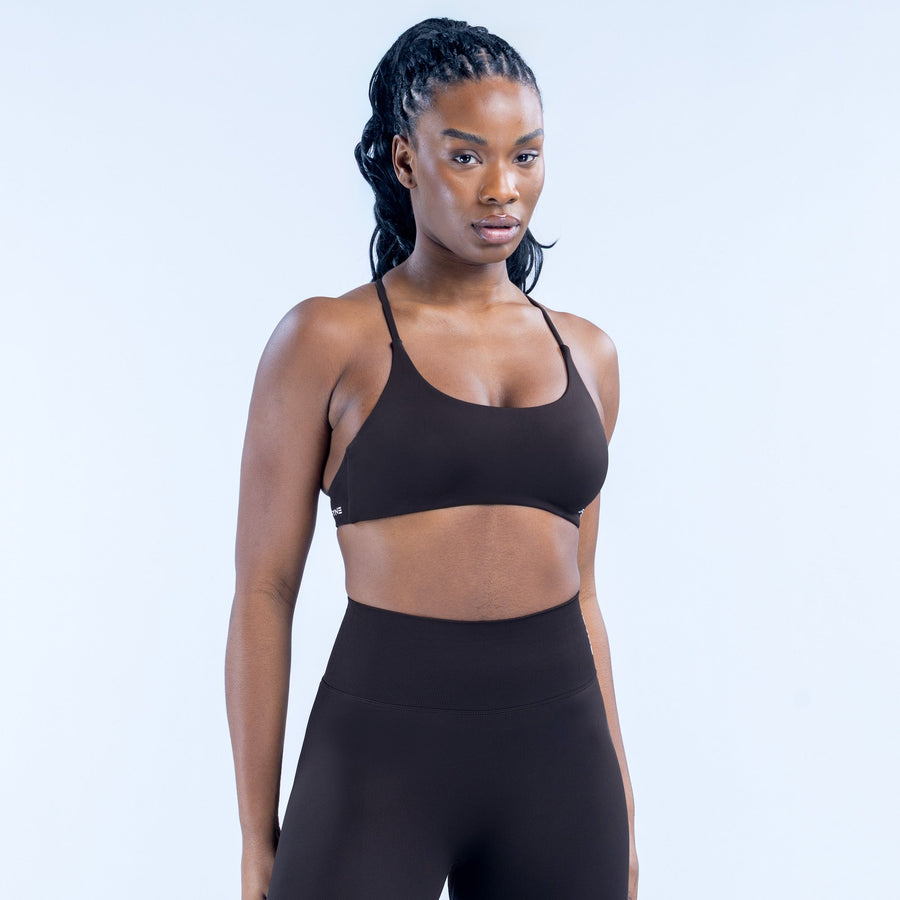 Black sports bra with thin double straps and smooth, supportive fit