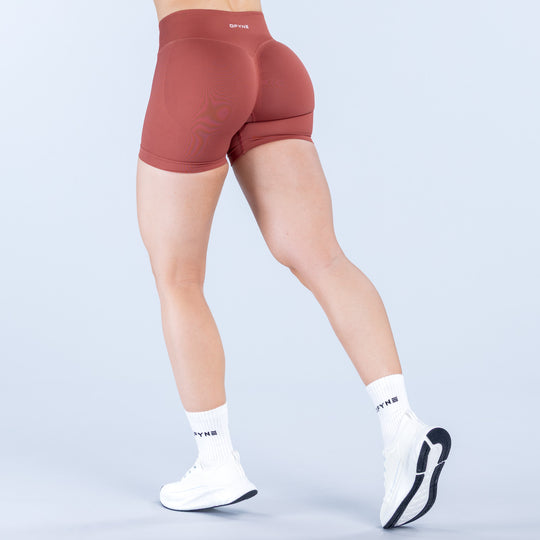 Rust red impact shorts with high-rise waistband and back seam detail