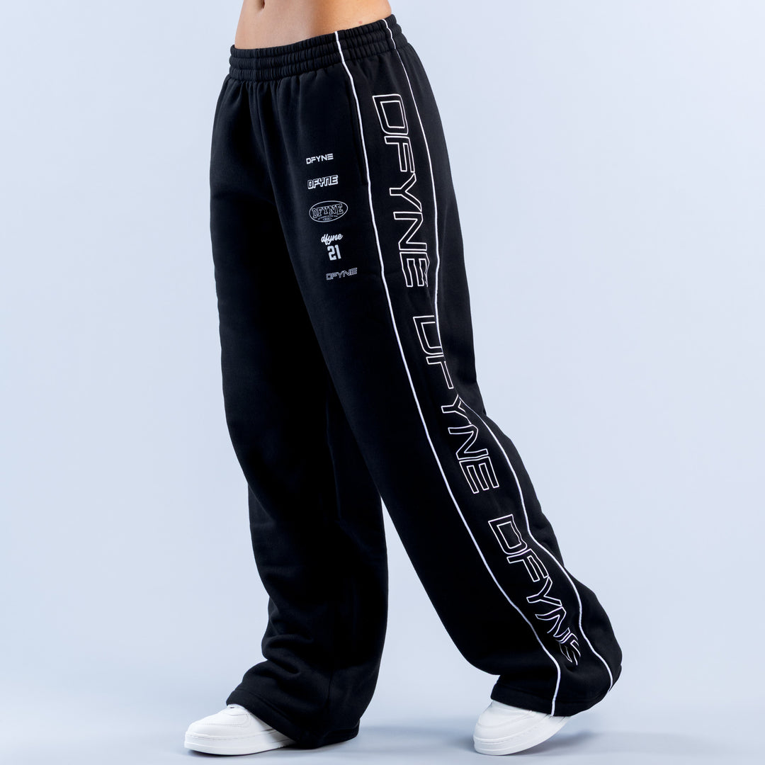 Black wide-leg joggers with elastic waistband and white side graphic print