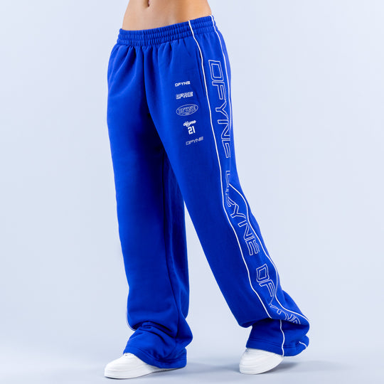 Blue wide-leg jogger pants showing side graphic and relaxed taper to ankle cuffs