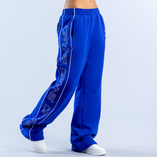 Blue wide-leg jogger pants with elastic cuffs and vertical side graphic lettering