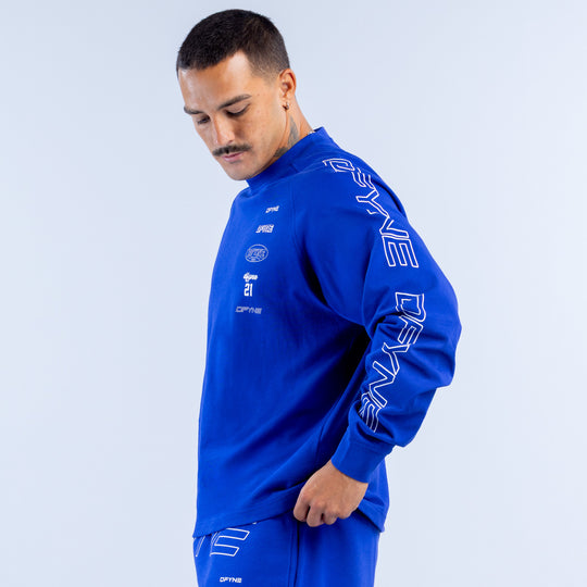 Blue long sleeve top with large white text graphics on sleeve