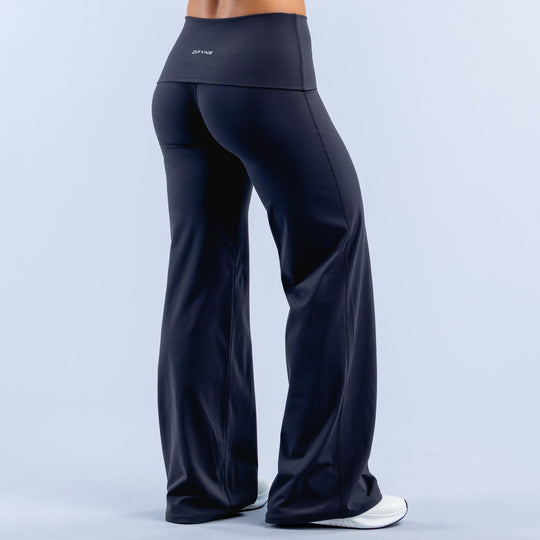 Dark navy wide-leg pants with fold-over waistband, side view, smooth drape