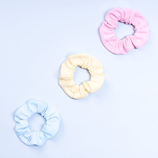 3-pack scrunchies in light pink, cream, and light blue with gathered elastic