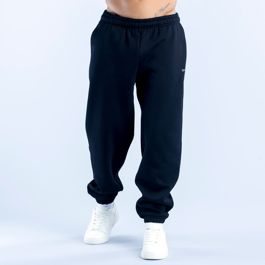 Dark navy joggers with elastic waistband, cuffed ankle hems, and side pockets.