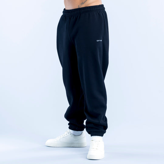 Dark navy joggers with elastic waist, cuffed hems, and small thigh logo.