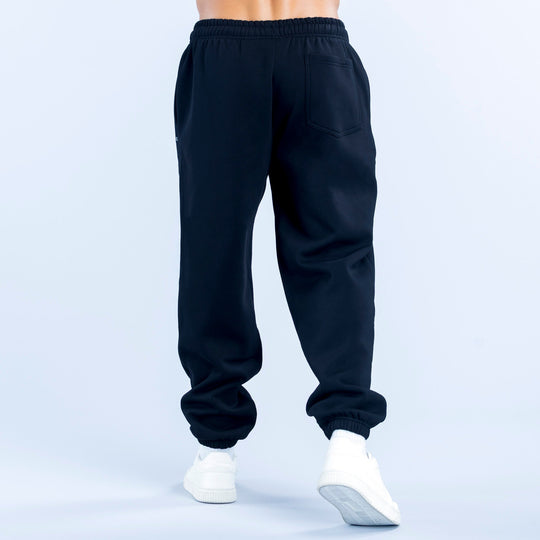 Dark navy joggers with elastic waist, cuffed hems, and a back pocket detail.