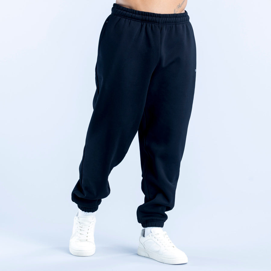 Dark navy tapered joggers with elastic waistband and cuffed ankle hems.