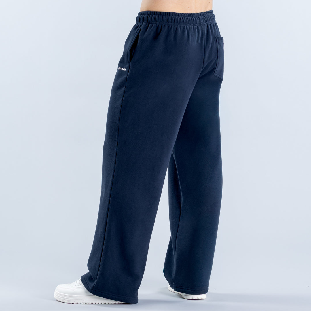 Navy straight-leg joggers with elastic waist and side pockets, shown from the side