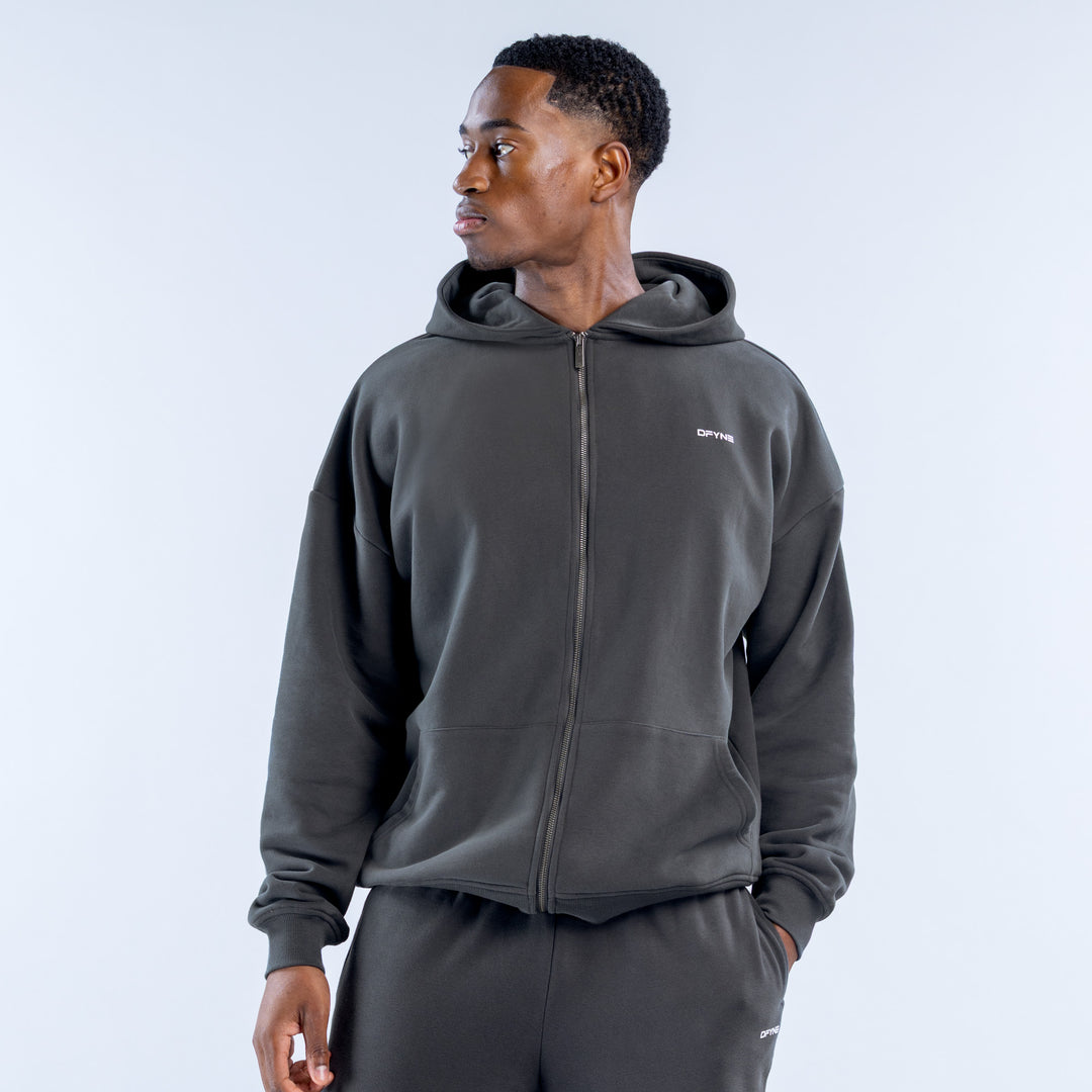 Dark gray heavyweight zip hoodie with hood, front pockets, and small chest logo.