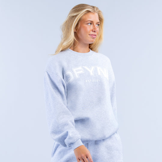 Light blue graphic sweatshirt with DEFYN logo, long sleeves and crew neck